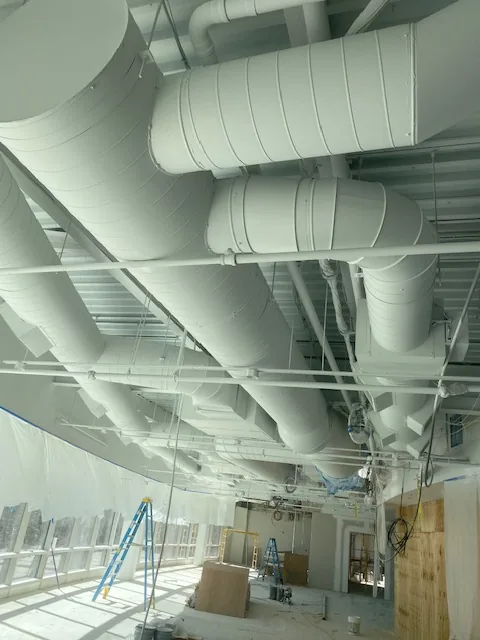 Commercial ceiling and ductwork finished in white