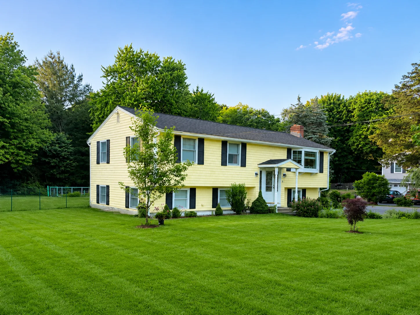 Completed yellow residential exterior with white trim