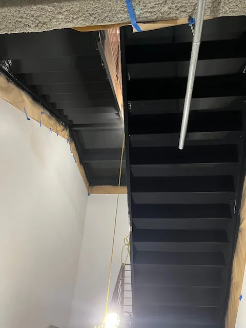 Residential staircase finished in a deep black stain