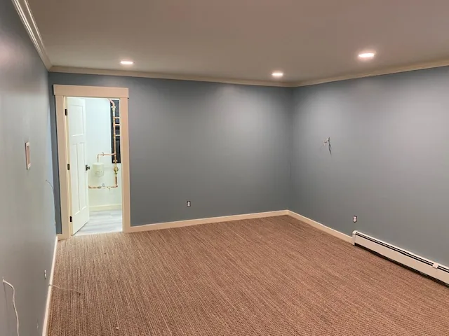 Gray residential room with access to finished bathroom