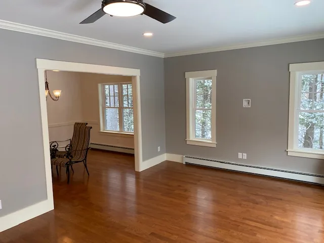 Finished gray residential room opening to a dining area