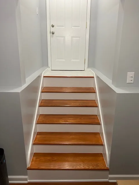 Residential staircase with stained wood treads and white risers